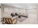 Bright and airy living room boasting an accent rug, contemporary furniture, and natural light from the windows at 14303 Glenayre Cir, Parker, CO 80134