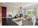 Comfortable living room with dark floors, fireplace, and large windows at 14303 Glenayre Cir, Parker, CO 80134