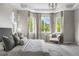 Main bedroom with bay window and elegant furnishings at 14303 Glenayre Cir, Parker, CO 80134