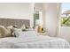 Main bedroom detail featuring neutral decor, padded headboard and side table at 14303 Glenayre Cir, Parker, CO 80134