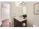 Bathroom featuring a vanity with a sink, a mirror, and neutral decor at 2038 S Columbine St, Denver, CO 80210