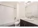 Cozy bathroom features a shower-tub combo, a modern sink, and light tiles for a clean, updated space at 2038 S Columbine St, Denver, CO 80210