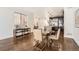 Open-concept dining area with a glass table connects to the kitchen, offering a great flow for entertaining at 2038 S Columbine St, Denver, CO 80210