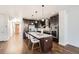 Modern kitchen with stainless steel appliances, center island with bar stools, and stylish pendant lights at 2038 S Columbine St, Denver, CO 80210