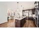 Bright kitchen with a center island, stainless steel appliances, and views of the dining area and windows at 2038 S Columbine St, Denver, CO 80210