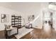 Bright living room with hardwood floors, plush armchairs, stylish decor, and an open doorway at 2038 S Columbine St, Denver, CO 80210