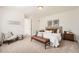 Inviting main bedroom with carpeted floors, a bench, and neutral decor at 2038 S Columbine St, Denver, CO 80210