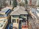 Back of the house with a grey roof, small patio, and small yard with fencing at 2038 S Columbine St, Denver, CO 80210