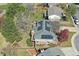 Aerial view of a brick home featuring solar panels on the roof and a beautifully landscaped yard at 6213 S Lima Way, Englewood, CO 80111
