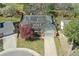 Aerial view of a home showcasing its well-manicured lawn, mature trees, and solar panels on the roof at 6213 S Lima Way, Englewood, CO 80111