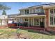 Backyard featuring an outdoor dining area, a hot tub for relaxation, and a well-maintained lawn at 6213 S Lima Way, Englewood, CO 80111