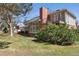 Spacious backyard features an outdoor seating area, well-maintained lawn, and mature trees for privacy at 6213 S Lima Way, Englewood, CO 80111