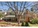 Spacious backyard featuring a covered patio, hot tub, mature trees, and solar panels for energy efficiency at 6213 S Lima Way, Englewood, CO 80111