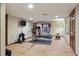 This basement offers a dedicated workout space with exercise equipment and a wall-mounted TV at 6213 S Lima Way, Englewood, CO 80111