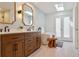 Modern bathroom featuring double vanities, a soaking tub, stylish mirrors and plenty of light at 6213 S Lima Way, Englewood, CO 80111