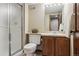 The bathroom features a walk-in shower, vanity with a sink, and neutral tones for a serene and clean space at 6213 S Lima Way, Englewood, CO 80111