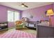 This Bedroom offers a calming atmosphere with soft purple walls, a cozy crib, and a charming sloth wall decal at 6213 S Lima Way, Englewood, CO 80111