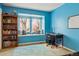 This bedroom features built-in seating area with natural light, complemented by a desk and bookshelf for studying at 6213 S Lima Way, Englewood, CO 80111