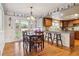 Inviting dining area with hardwood floors, view into the kitchen, and access to backyard at 6213 S Lima Way, Englewood, CO 80111