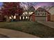 Charming brick home with two-car garage, mature trees, and well-manicured lawn at 6213 S Lima Way, Englewood, CO 80111