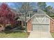Two-story home with a red brick facade, a well-maintained lawn and solar panels on the roof at 6213 S Lima Way, Englewood, CO 80111