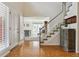 Bright foyer featuring hardwood floors, staircase, and view into the living room at 6213 S Lima Way, Englewood, CO 80111