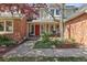 Charming brick home featuring a welcoming front porch and beautifully landscaped garden at 6213 S Lima Way, Englewood, CO 80111