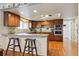 Updated kitchen features custom cabinets, modern appliances, and a breakfast bar at 6213 S Lima Way, Englewood, CO 80111