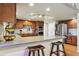 Well-appointed kitchen boasts custom cabinets, stainless appliances, and eat-in breakfast bar at 6213 S Lima Way, Englewood, CO 80111
