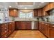 Beautiful kitchen featuring custom wood cabinets, stainless steel appliances, and ample counter space at 6213 S Lima Way, Englewood, CO 80111