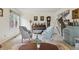 Bright living room featuring a piano, comfortable seating, and staircase to the second floor at 6213 S Lima Way, Englewood, CO 80111