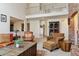 Spacious living room with brick accent wall, comfortable seating, and unique trunk-style coffee table at 6213 S Lima Way, Englewood, CO 80111