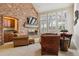 Inviting living room features a brick fireplace, comfortable seating, and large windows for natural light at 6213 S Lima Way, Englewood, CO 80111