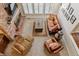 Aerial view of living room showcasing brick fireplace, comfortable seating, and large windows at 6213 S Lima Way, Englewood, CO 80111