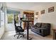 Home office featuring a standing desk, comfortable seating, and a large bookcase at 6213 S Lima Way, Englewood, CO 80111