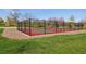 Outdoor pickleball court fenced in and surrounded by gravel at 6213 S Lima Way, Englewood, CO 80111