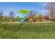 Colorful community playground area with slides and climbing structures, ideal for Gathering fun at 6213 S Lima Way, Englewood, CO 80111