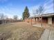 Large backyard with a covered patio and two storage sheds, perfect for outdoor entertaining and additional storage space at 1153 Sherman St, Longmont, CO 80501