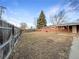 Large backyard with a covered patio and two storage sheds, perfect for outdoor entertaining and additional storage space at 1153 Sherman St, Longmont, CO 80501