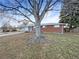 Charming red brick home featuring a well-maintained lawn and attached one car garage, perfect for a starter home or investment at 1153 Sherman St, Longmont, CO 80501