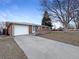 Charming red brick home featuring a well-maintained lawn and attached one car garage, perfect for a starter home or investment at 1153 Sherman St, Longmont, CO 80501