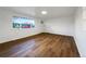 Bright living room with new hardwood floors, fresh white walls and ample natural light, perfect for entertaining guests at 1153 Sherman St, Longmont, CO 80501