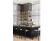 Upscale bar area with modern shelving, a bartender, and comfortable seating at 1133 14Th St # 4150, Denver, CO 80202
