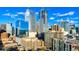 Stunning cityscape view with modern glass buildings against a bright blue sky with scattered clouds at 1133 14Th St # 4150, Denver, CO 80202