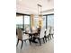 Dining room with a large table, comfortable seating, modern chandelier, and expansive city views at 1133 14Th St # 4150, Denver, CO 80202