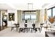 Elegant dining room with a long table, stylish chairs, modern lighting, and a view of the city at 1133 14Th St # 4150, Denver, CO 80202