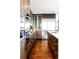 Contemporary kitchen with stainless steel appliances, sleek cabinetry, and a center island with a sink at 1133 14Th St # 4150, Denver, CO 80202