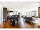Expansive living area with a grand piano, modern decor, and open layout connecting to the kitchen and dining area at 1133 14Th St # 4150, Denver, CO 80202