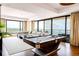 Open living room with modern decor, pool table, and large windows showcasing city views at 1133 14Th St # 4150, Denver, CO 80202