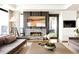 Elegant living room with a modern fireplace, stylish decor, comfortable seating, and access to a balcony at 1133 14Th St # 4150, Denver, CO 80202